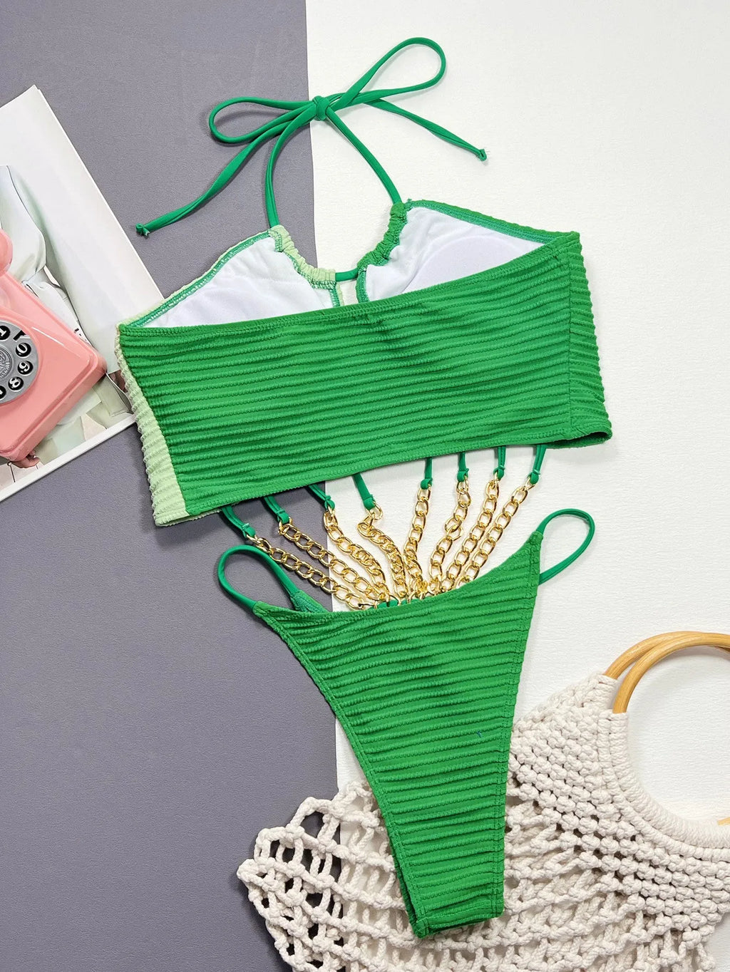 Green women's one-piece swimsuit with hollow design on mannequin