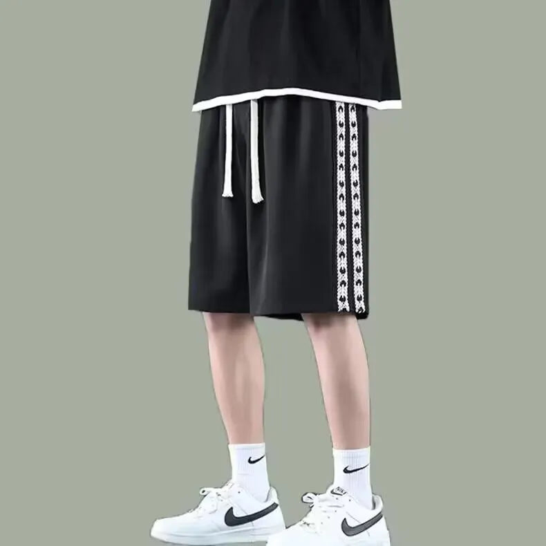 Men's black baggy track pants with loose fit and elastic waistband