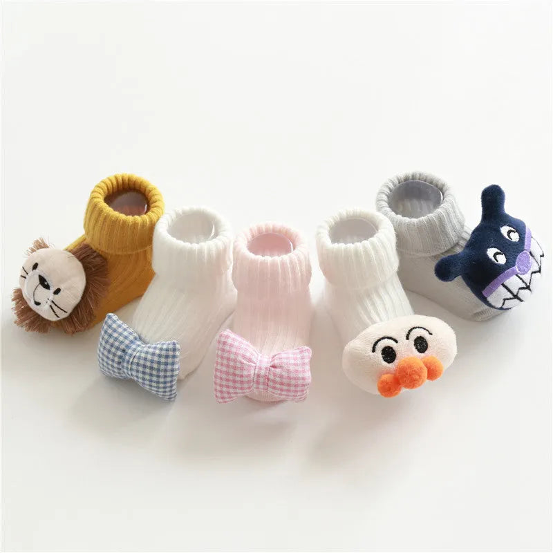 Cotton baby socks in multiple colours including blue bow and pink stars on a white background
