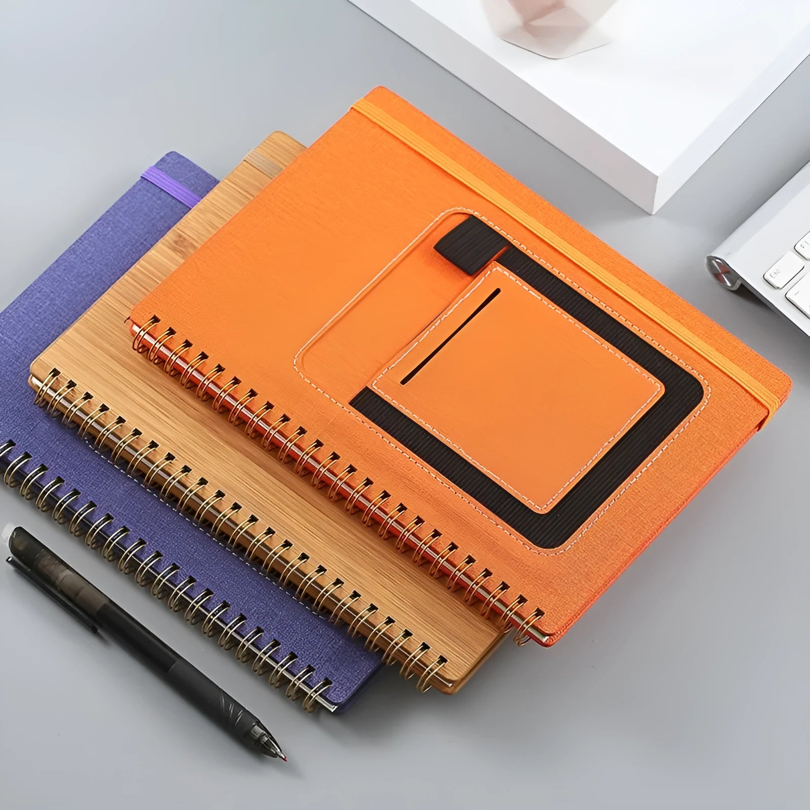 Erasable coil notebook with customisable cover options including black, blue, brown, red, sky blue and wood grain finishes