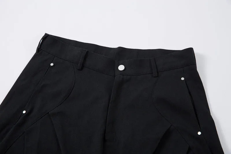 Men's black cotton trousers with pleated machete detailing and loose-fitting wide-leg silhouette