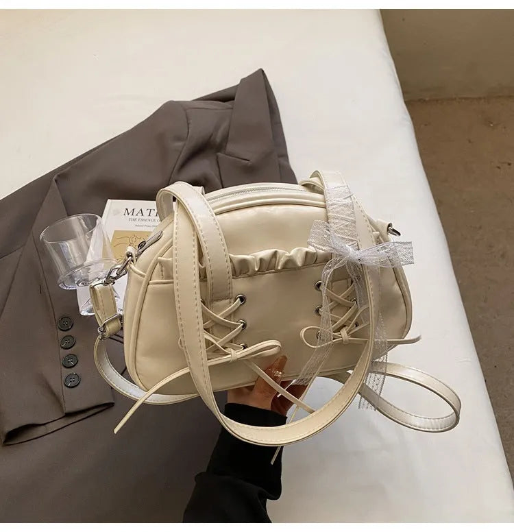 Women's fashion shoulder handbag with bandage bow design in PU leather showing interior phone pocket