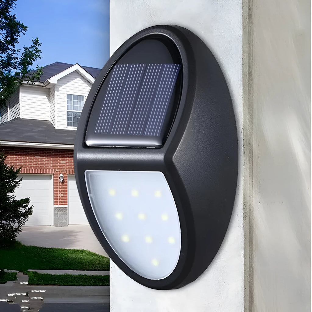 Compact black rectangular solar-powered LED wall light mounted on an outdoor wall.