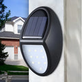 Compact black rectangular solar-powered LED wall light mounted on an outdoor wall.