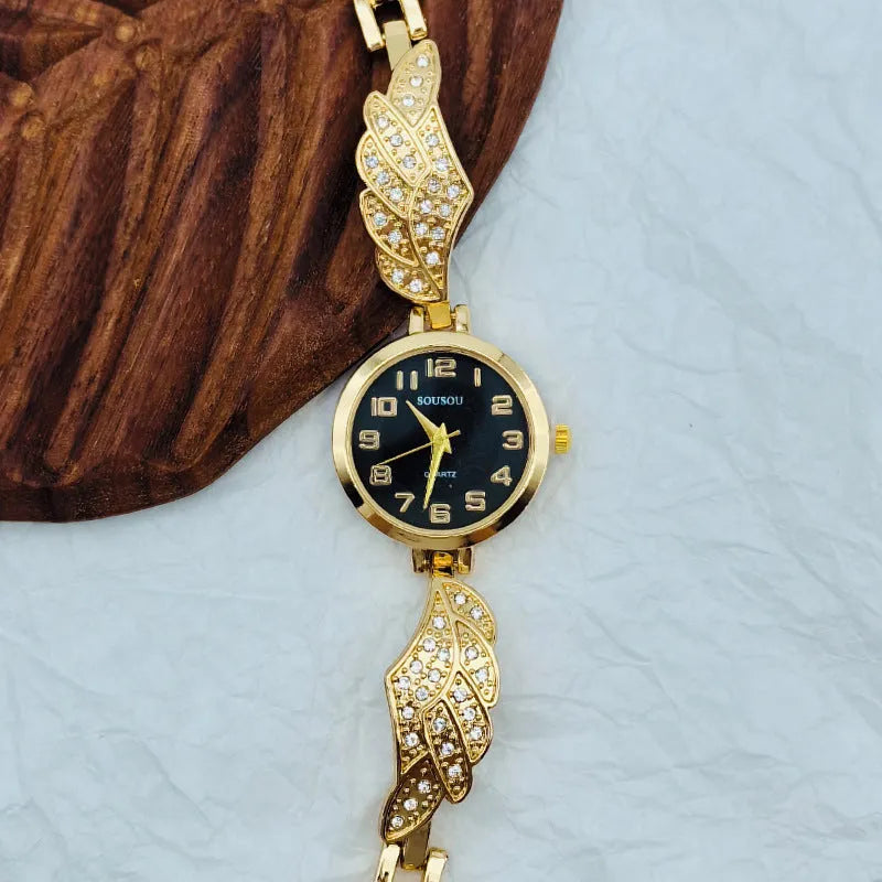 Women's stainless steel watch with round dial on wrist, showing gold face colour option and vachette clasp.