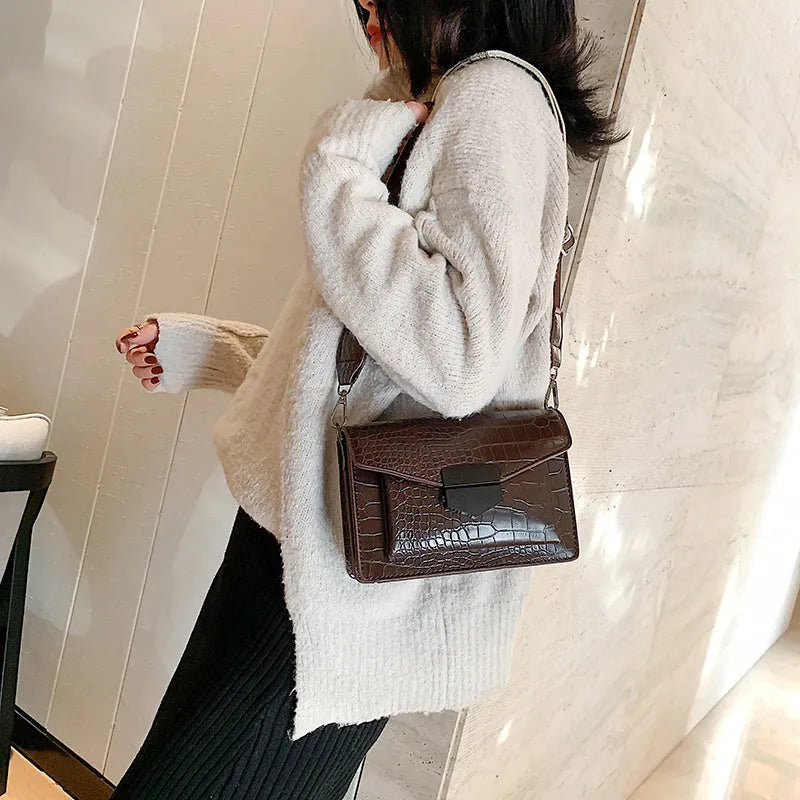 Vintage style crossbody bag in PU material showing 20cm width with four colour options