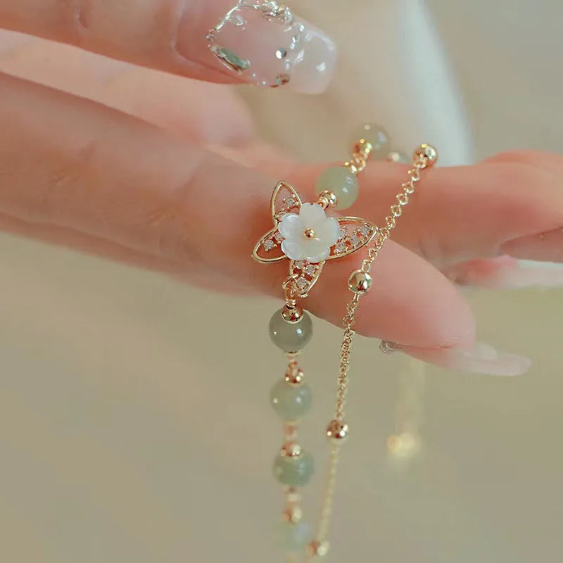Yellow gold electroplated copper butterfly bracelet with geometric shape and bells of Ireland Hetian jade charm