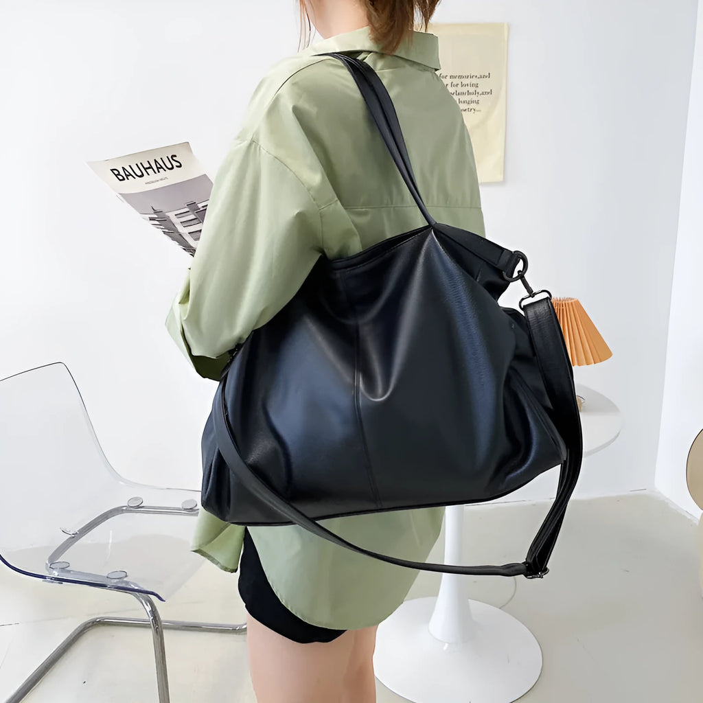 Large horizontal PU messenger bag with soft surface and shoulder strap in black colour