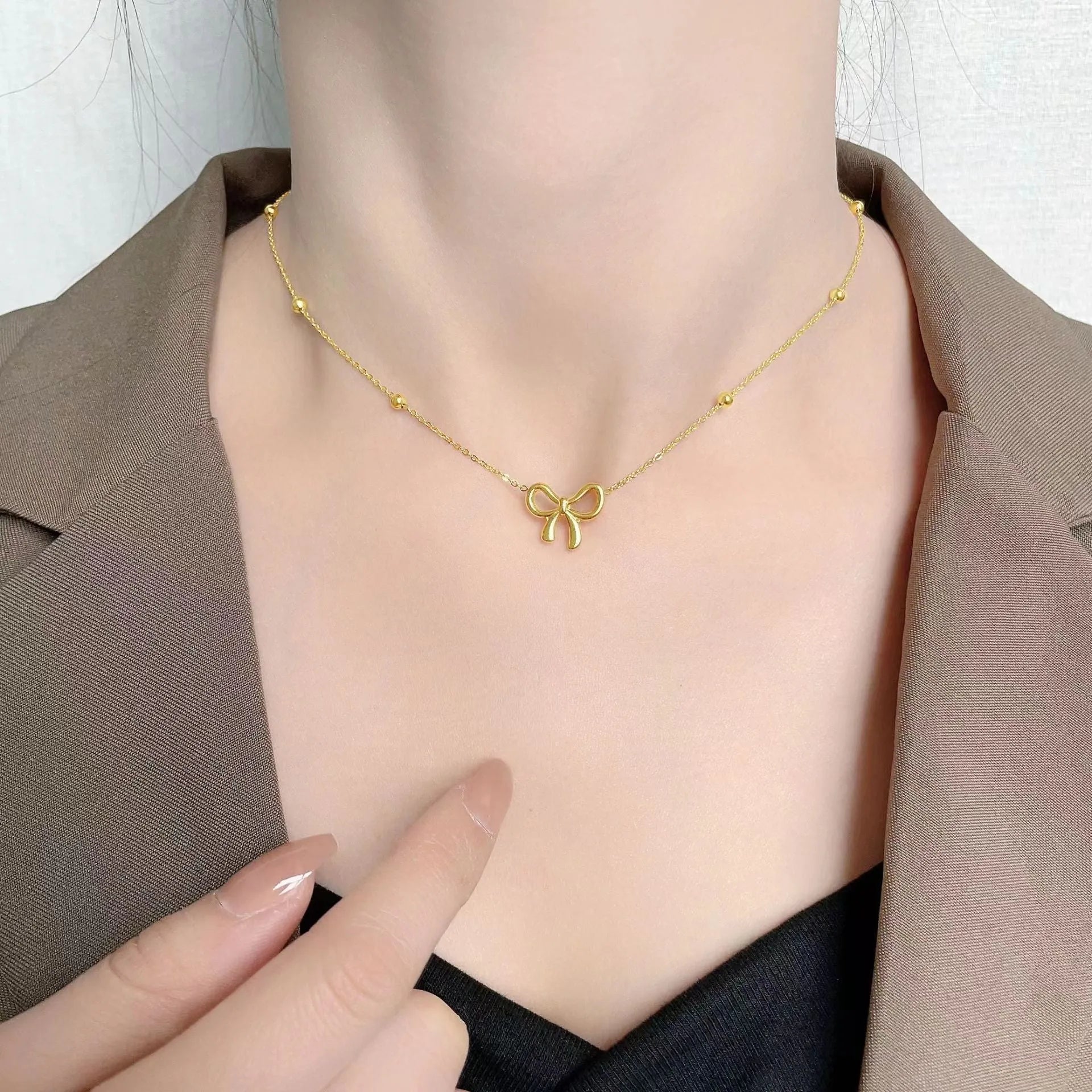 Gold bow necklace on titanium steel cross chain with adjustable 41-50cm length