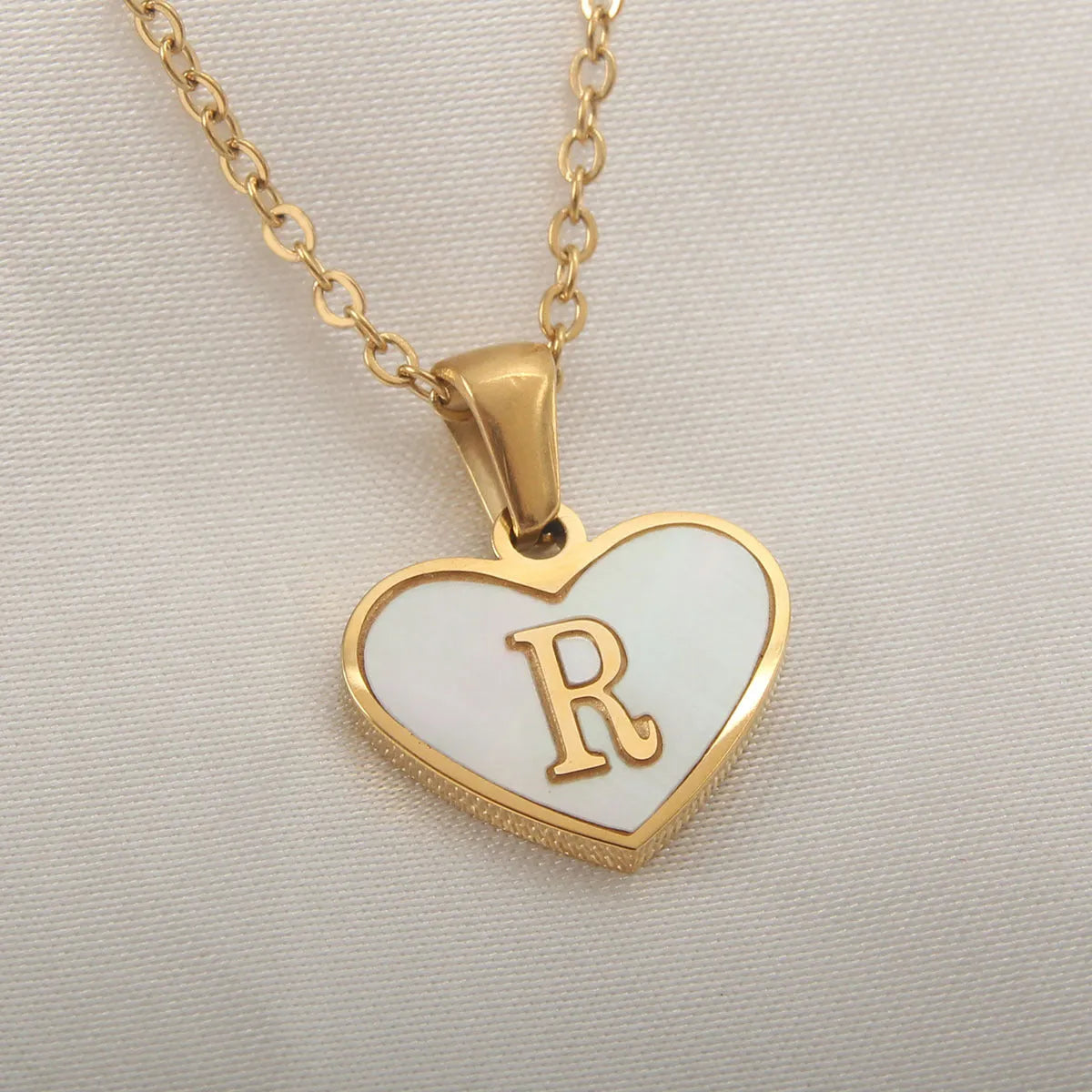 Gold plated heart necklace with white shell detail on an adjustable chain