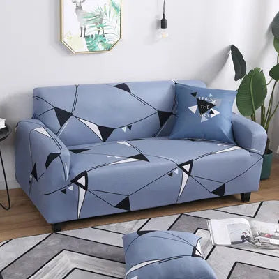 Geometric print stretch sofa slipcover fitted on a grey three-seater sofa.