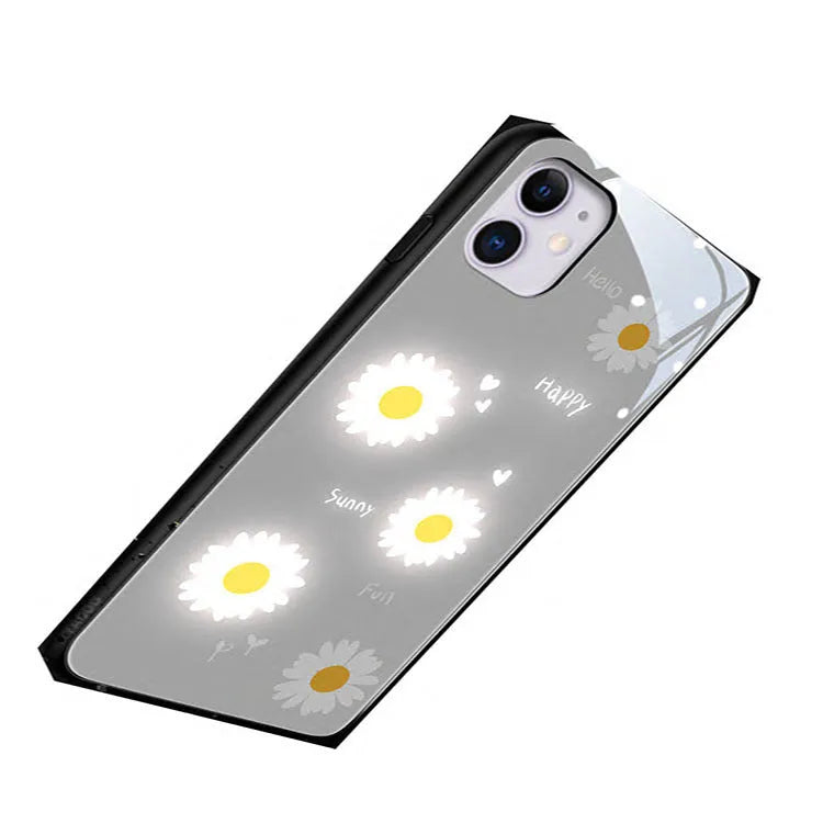 Luminous phone case for iPhone with voice-activated colour light showing painted daisy design on white TPU material