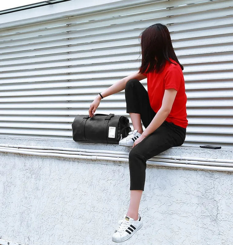 Black waterproof sports bag with separate shoe compartments and diagonal straps in two size options.
