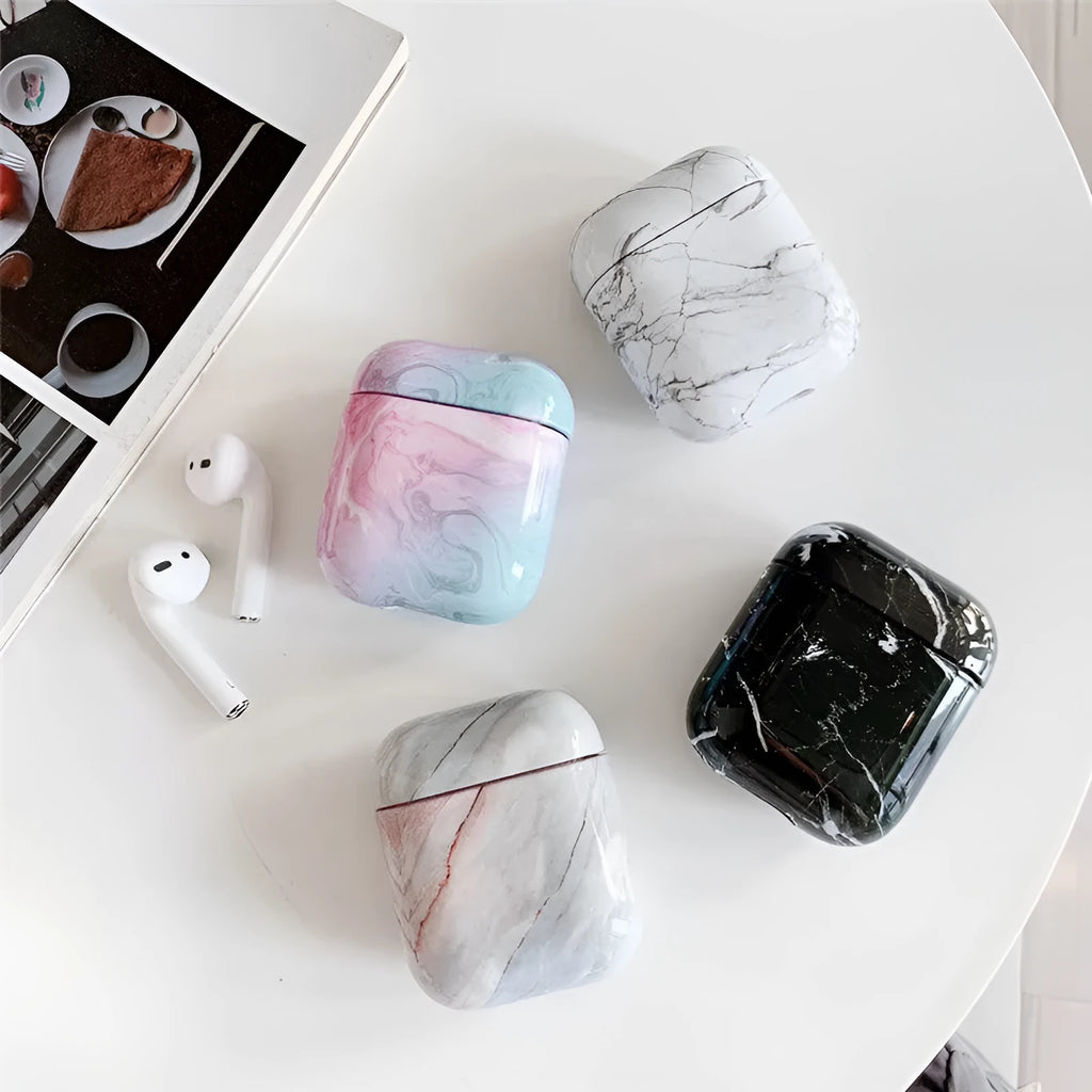 Hard white marble-pattern PC protective case fitted on an AirPods wireless earbud charging box.
