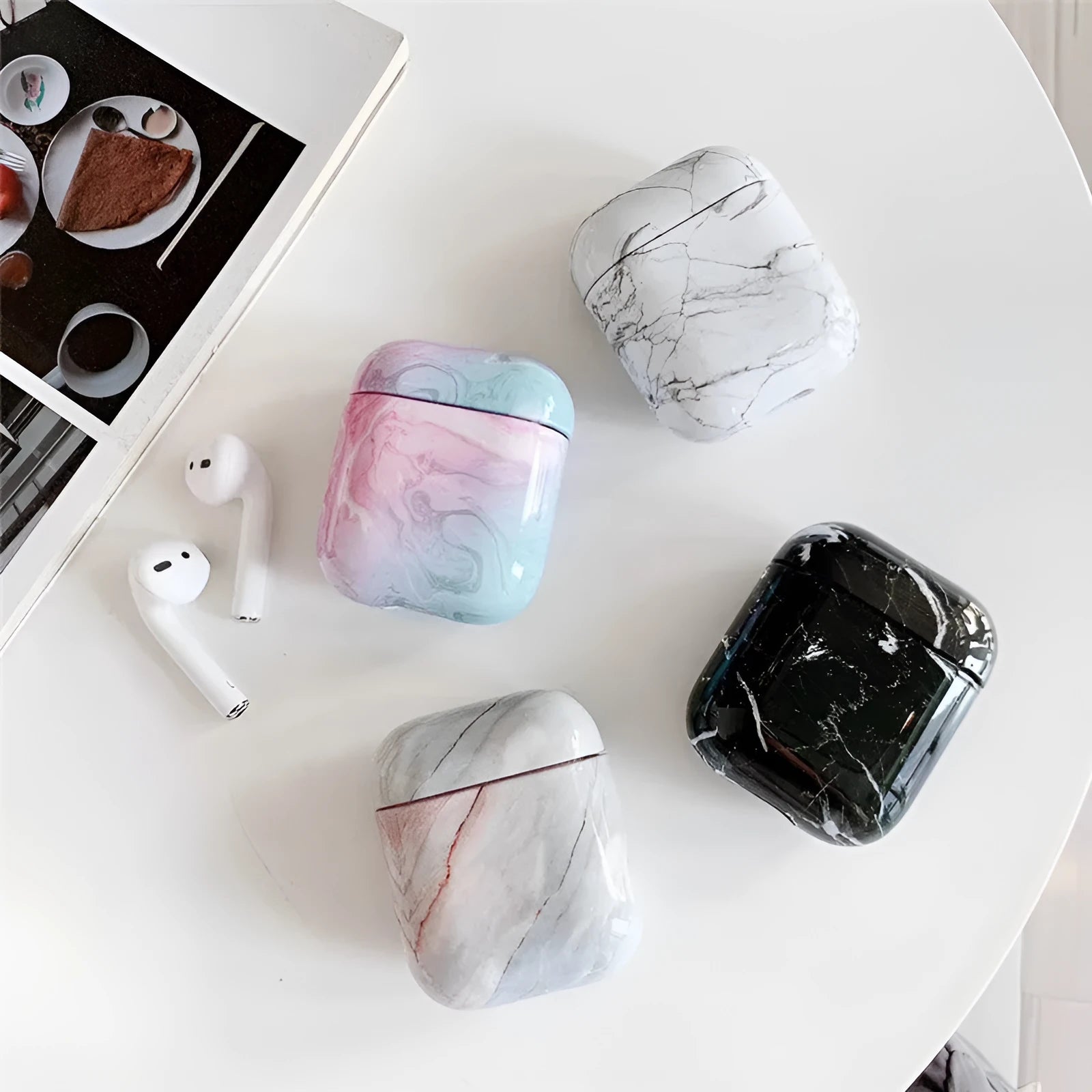 Hard white marble-pattern PC protective case fitted on an AirPods wireless earbud charging box.
