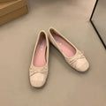 Wine red Mary Jane ballet flats with a bow and square toe on a rubber sole.
