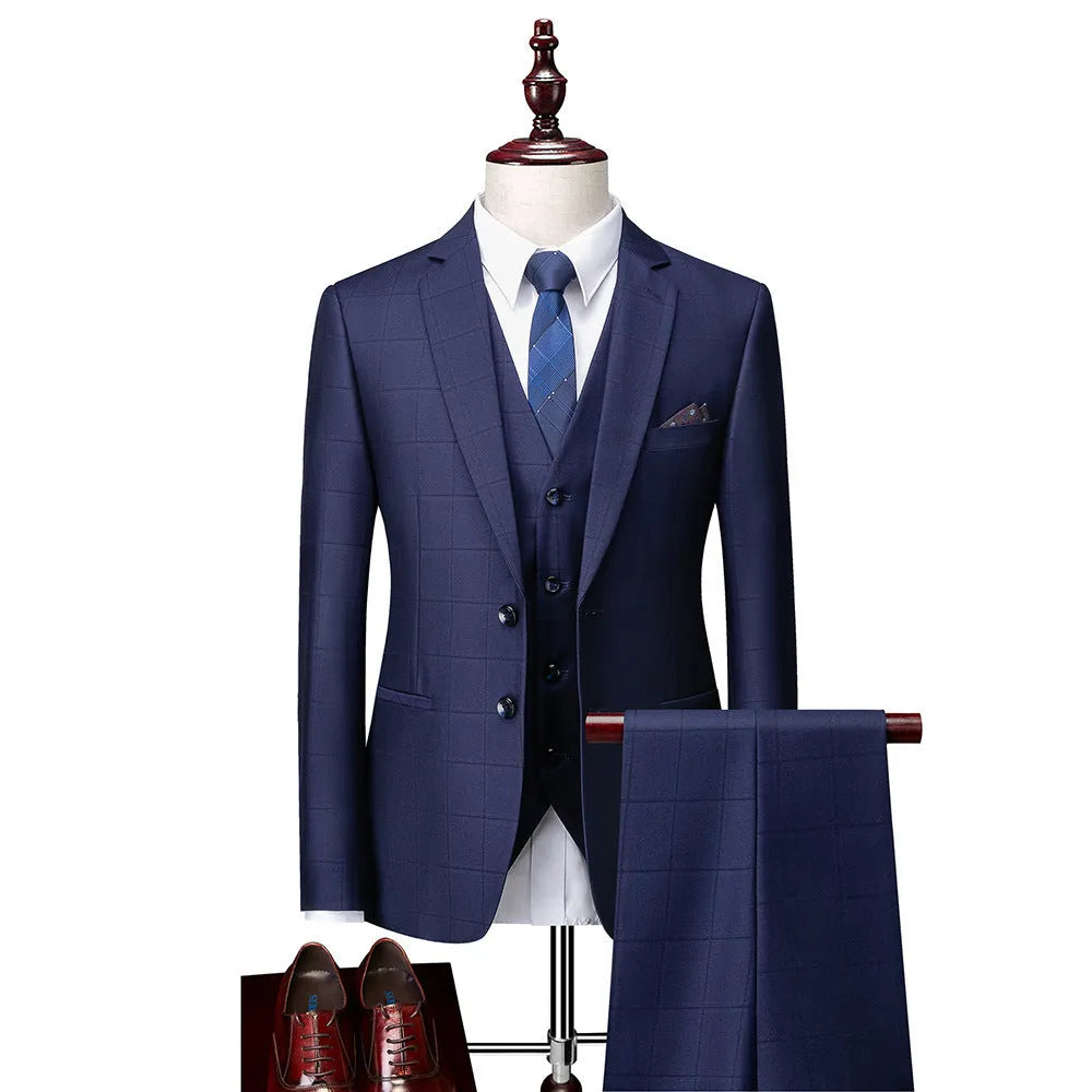 Men's navy blue slim fit three-piece suit with jacket, vest, and trousers on a hanger.
