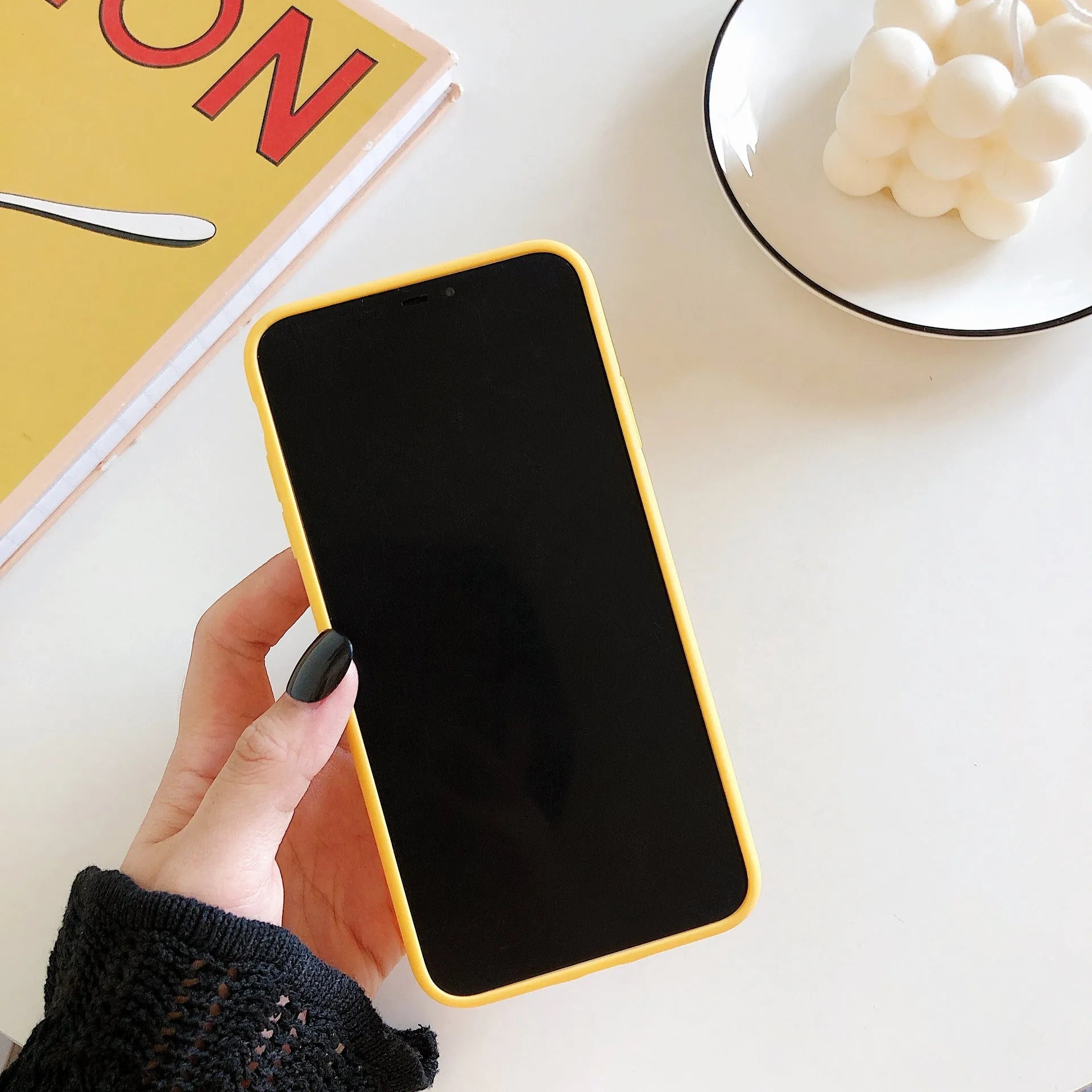 Hard back iPhone case with a solid colour and a graphic of an open banana peel.