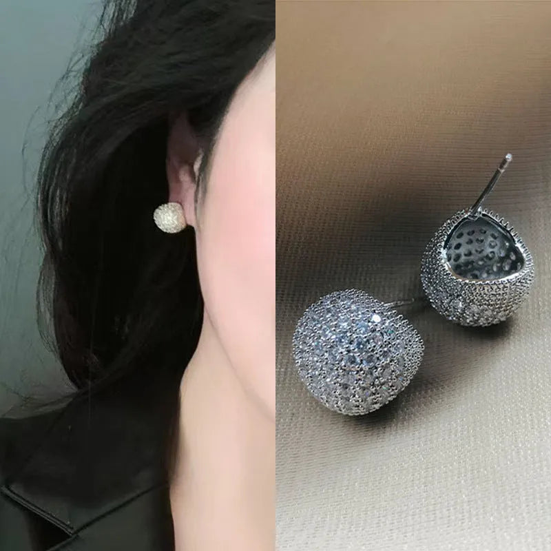 Geometric drop earrings with diamond accents and golden beans in gold and white colours