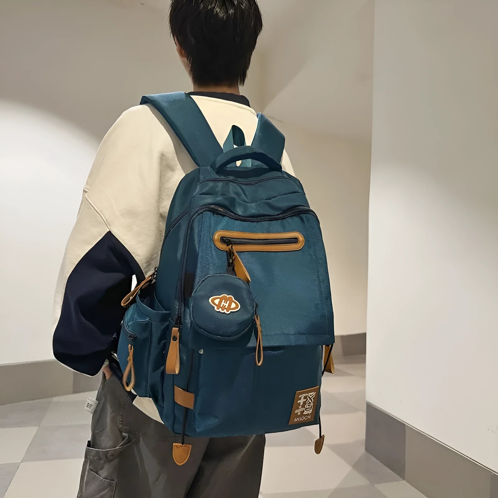 Large-capacity black nylon backpack for middle school students with curved shoulder straps and street style design