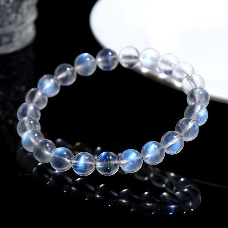 Natural cream coloured crystal bracelet on a wrist showing its simple unisex design and smooth ground beads.