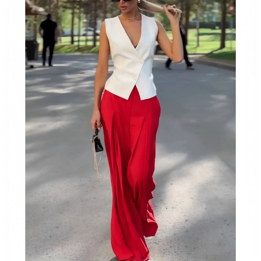 Women's beige two-piece set with deep V-neck sleeveless top and high-waisted wide-leg trousers.
