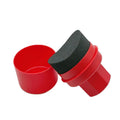 Black and red tyre polishing sponge brushes with protective lids on a white background