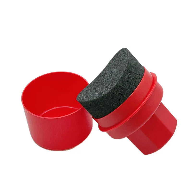 Black and red tyre polishing sponge brushes with protective lids on a white background