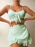 Women's white three-piece bikini swimsuit with a split hip skirt laid flat.