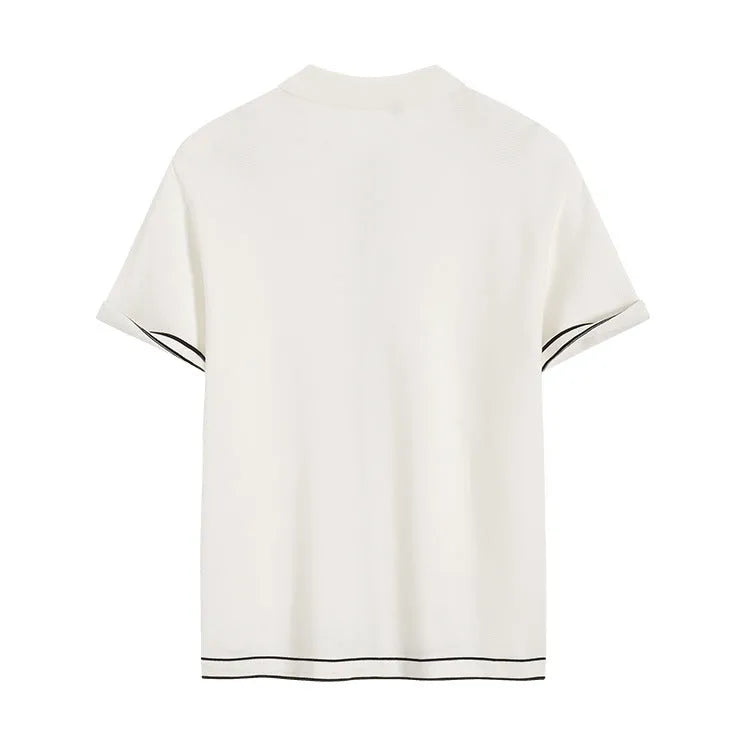 White short sleeve women's cardigan with dark contrasting lapels laid flat.