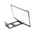 12 inch black ABS mobile screen magnifier with HD acrylic lens on a desk, showing a phone held in anti-slip slot