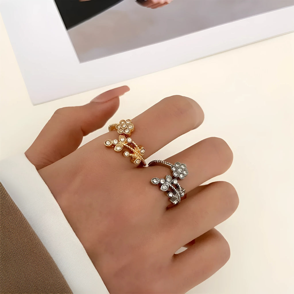 Women's open ring with flower and leaf design on a copper base with a diamond finish.