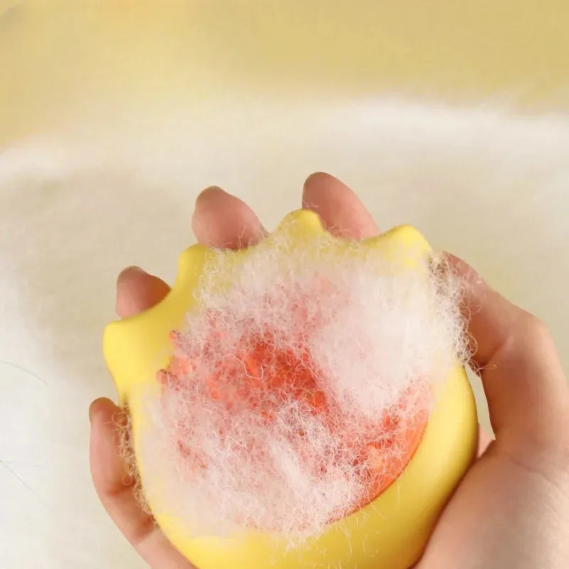 Blue pet bath brush with an integrated shampoo box, shown next to an orange and yellow version.