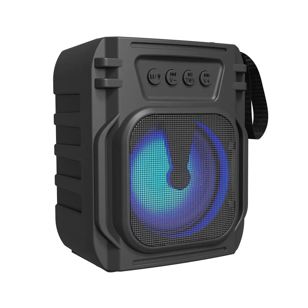 Small portable Bluetooth speaker in colour 3107 with USB charging cable on a desk