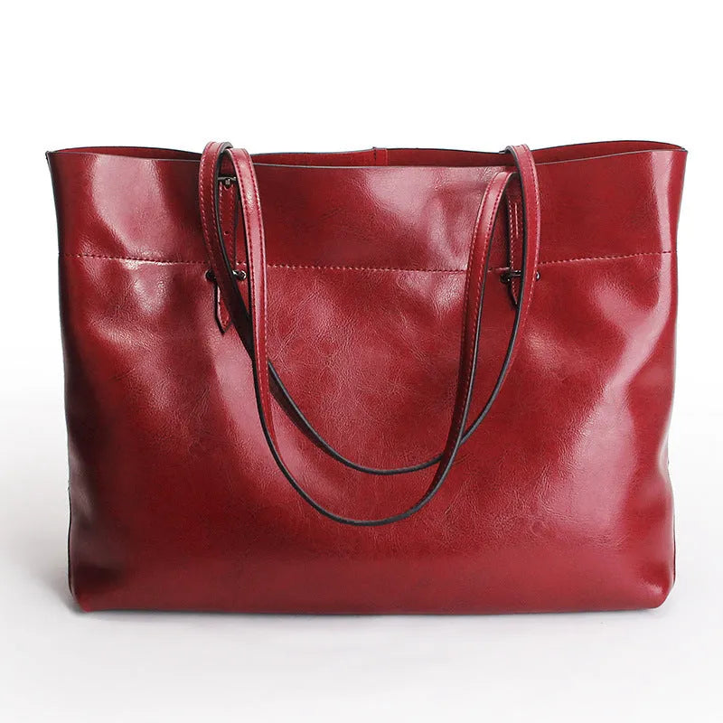Horizontal waxed cowhide leather cross-body handbag showing two main compartments and phone pocket organisation