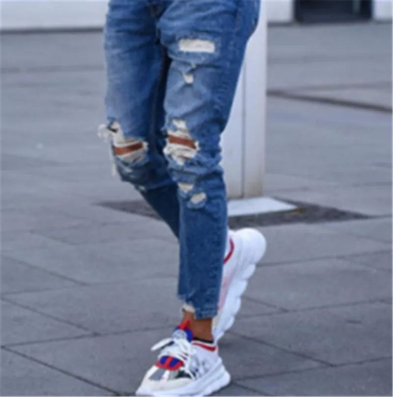Deep blue men's jeans with distressed hole detailing on cotton fabric showing front and back views