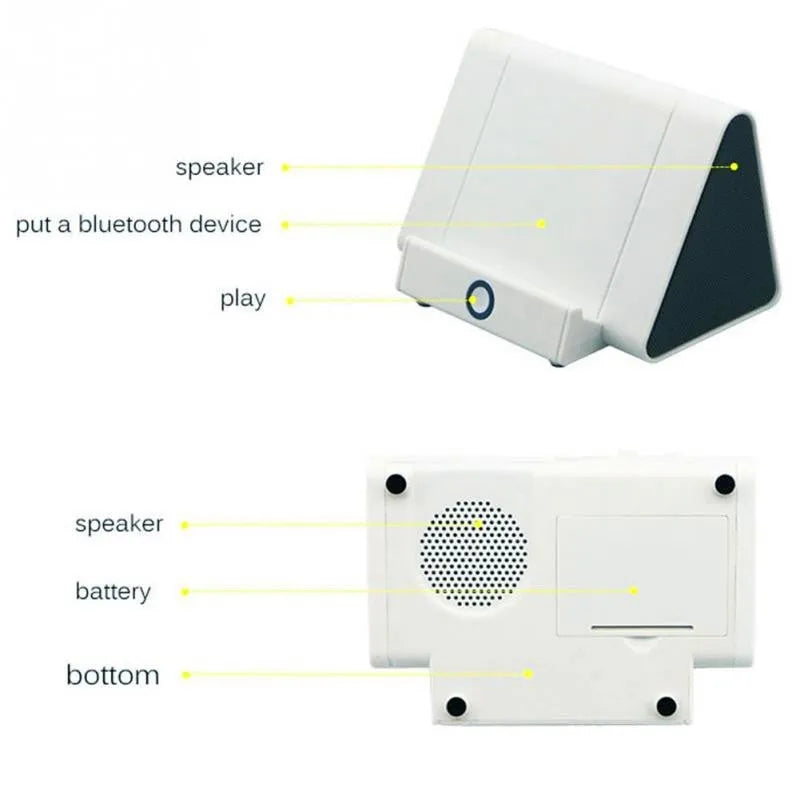 Small black and white wireless Bluetooth speaker with built-in charging cable.