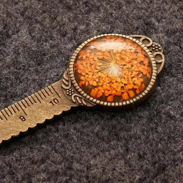 Handmade dried flower bookmark with ruler showing lace flowers, daffodils, and clover at 12cm length