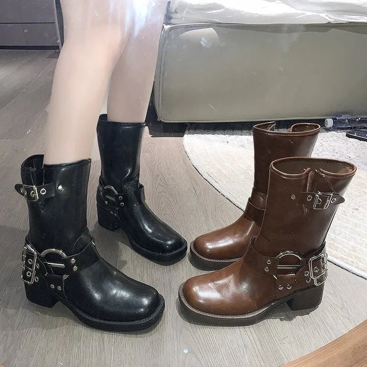 Black women's platform boots with a belt buckle detail on the shaft, shown in mid-calf length.