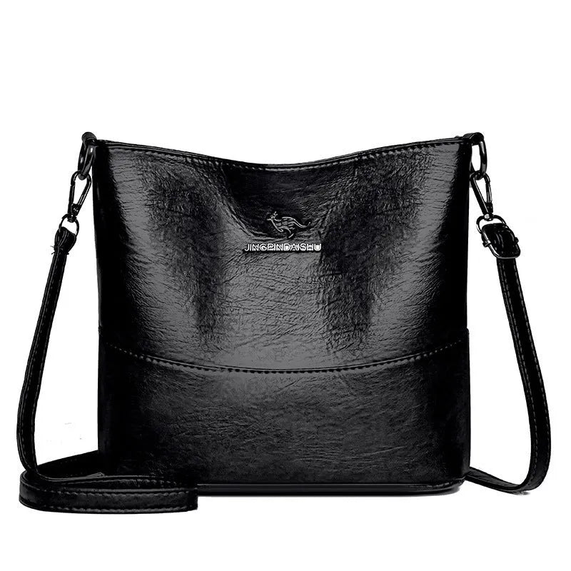 Women's black soft leather bucket-style shoulder bag with minimalist design and visible stitching