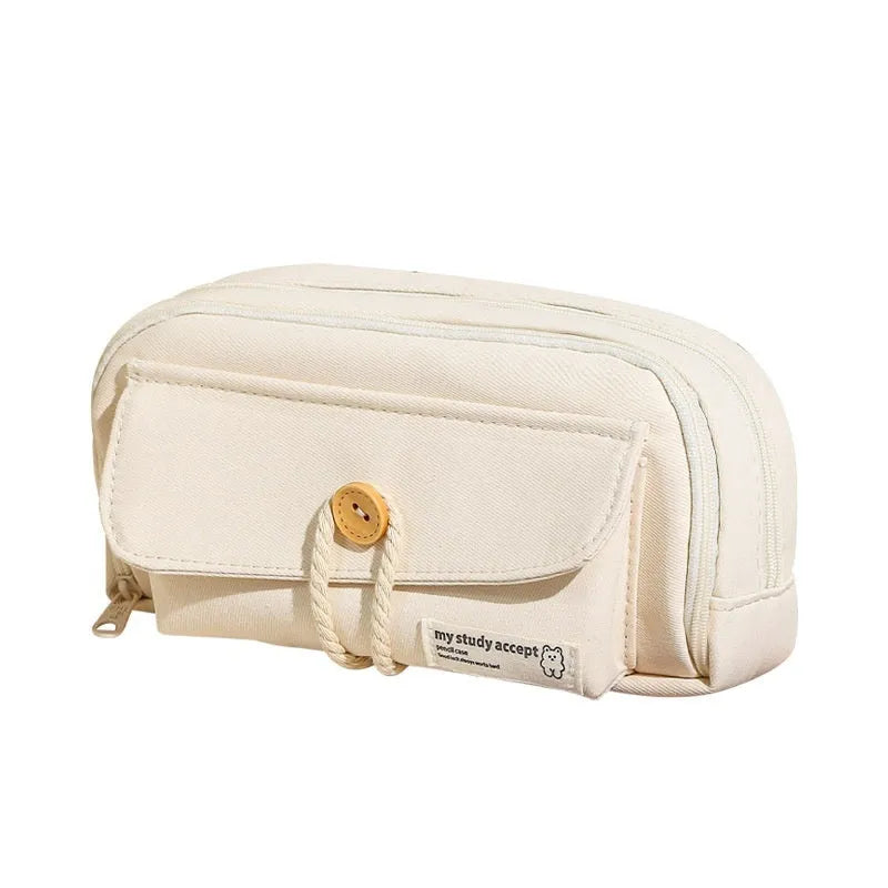 Canvas button-closure pencil case in beige, shown open with pens inside, demonstrating its large capacity.