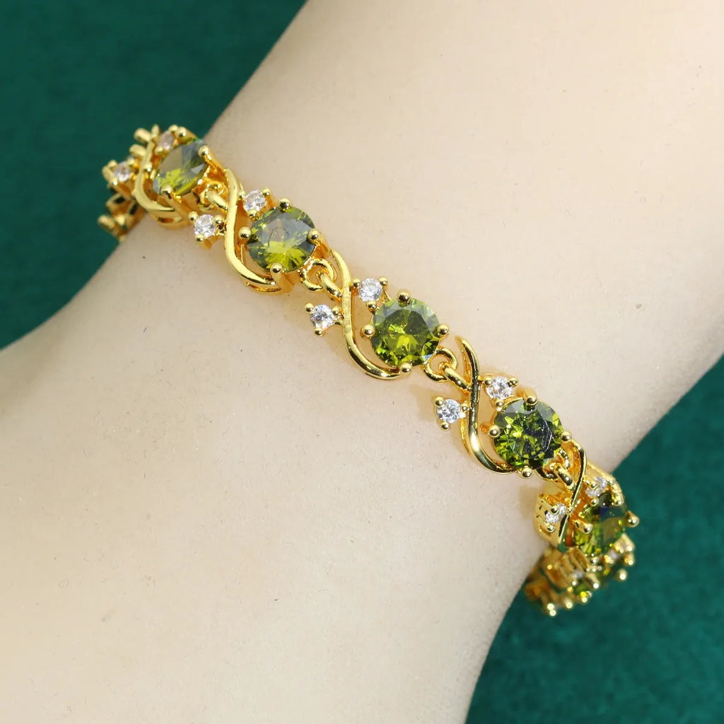 Female model wearing a golden green AAA zircon inlaid copper bracelet with a retro leaf shape design.