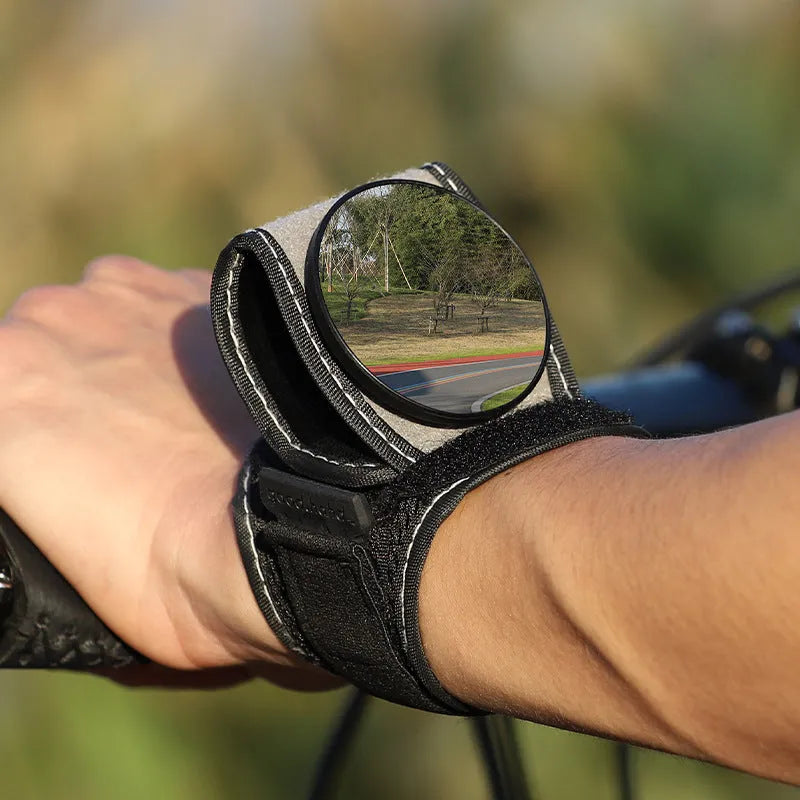 Black wrist-mounted bicycle rear-view mirror with adjustable arm for cycling safety