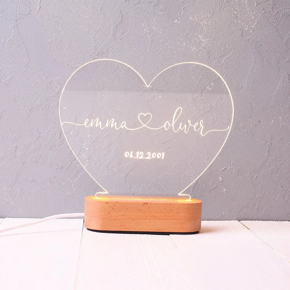 Custom acrylic night light with illuminated personalised names and dates for bedroom