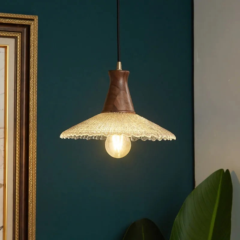 Retro-style brass and glass chandelier with a wooden frame hanging from a ceiling.