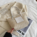Straw woven women's shoulder bag in black with three-dimensional pockets and 27cm width