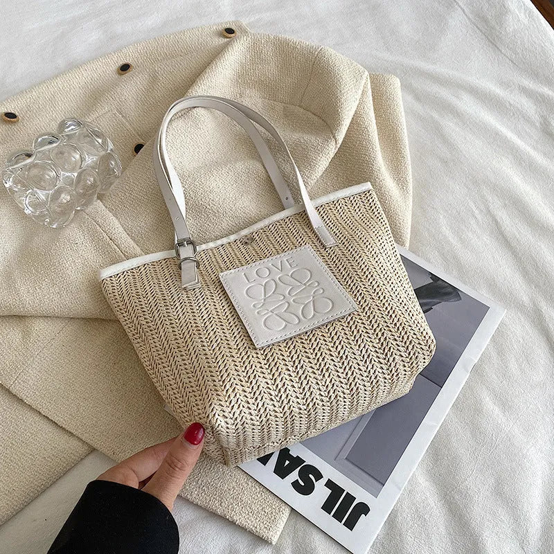 Straw woven women's shoulder bag in black with three-dimensional pockets and 27cm width