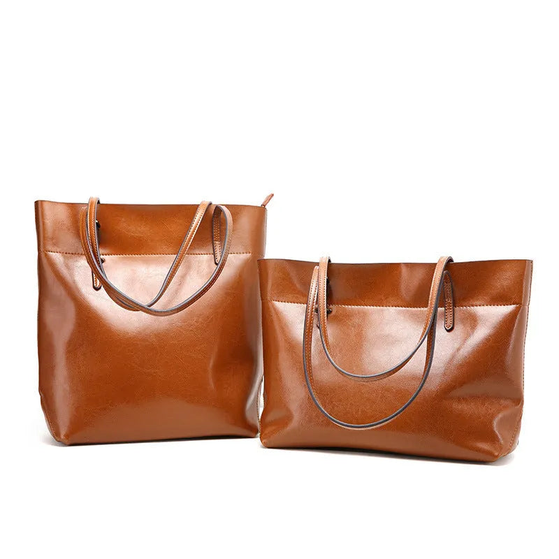 Horizontal waxed cowhide leather cross-body handbag showing two main compartments and phone pocket organisation
