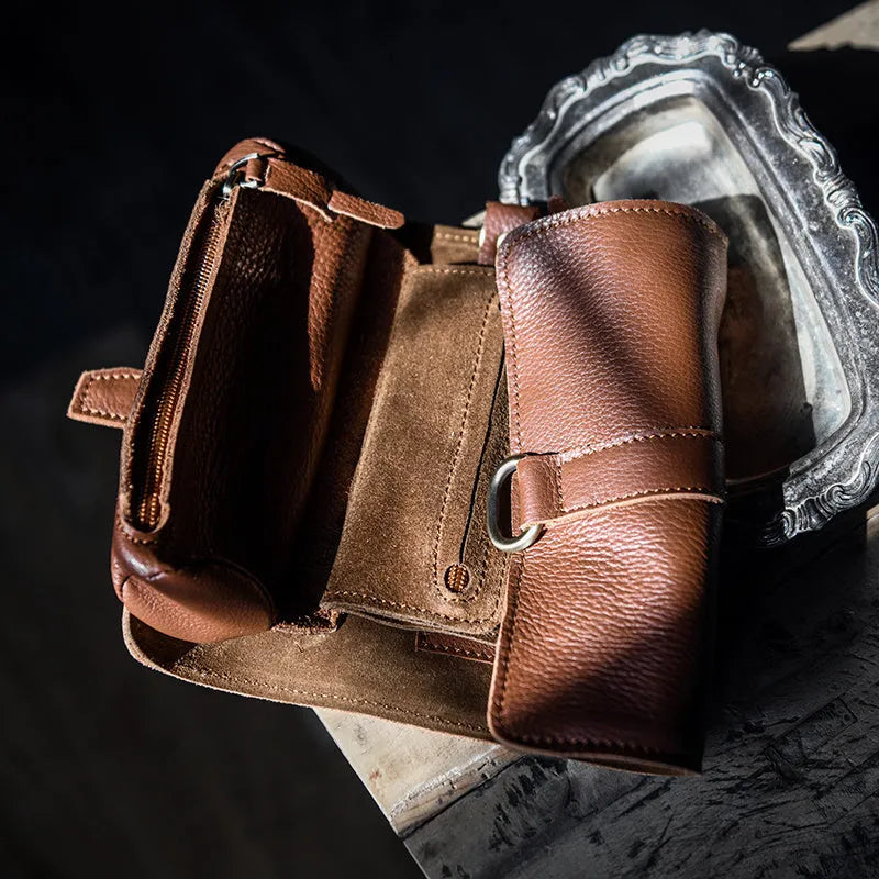 Handmade solid colour cow leather vintage wallet with tape closure, shown in black and dark brown.