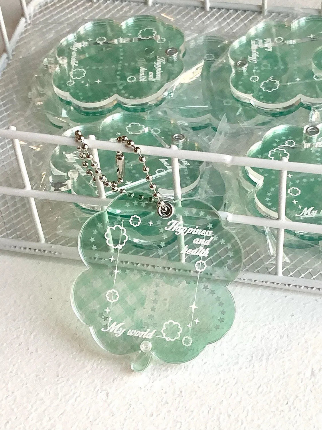 Lucky four-leaf clover shaped acrylic pendant keychain in blue, green, or mint green colours.